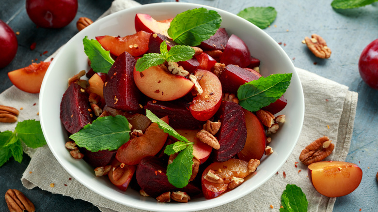 A beach and beat salad topped with mint leaves