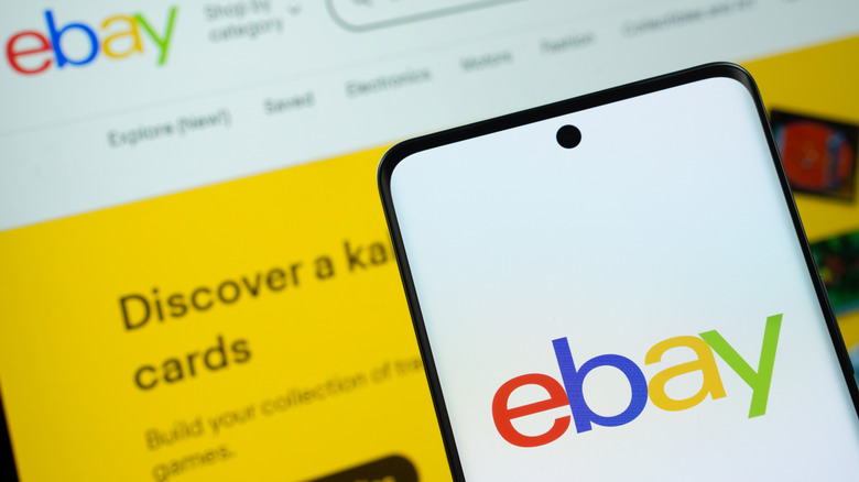 Smartphone and laptop screen with eBay logo on display.