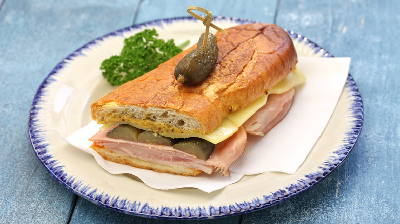 A Cuban sandwich on blue-trimmed plate