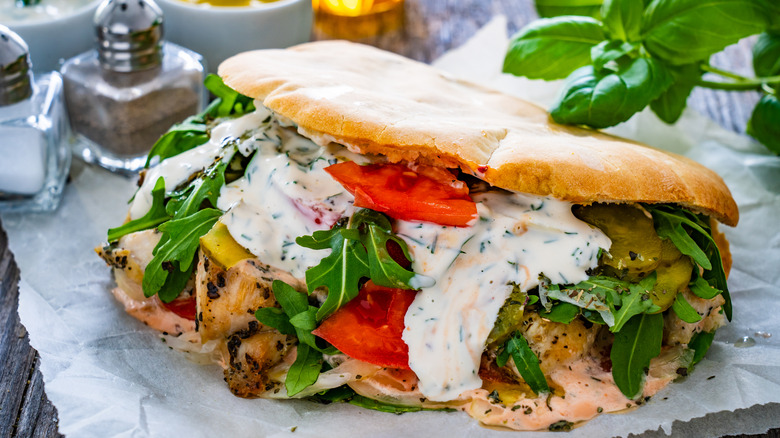 A large messy pita sandwich