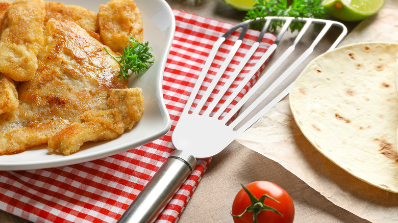 fish spatula next to plate of breaded filets