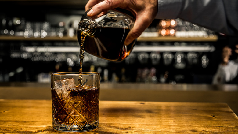 Man pouring whiskey into glass