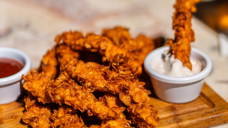 Fried chicken tenders served with two dipping sauces