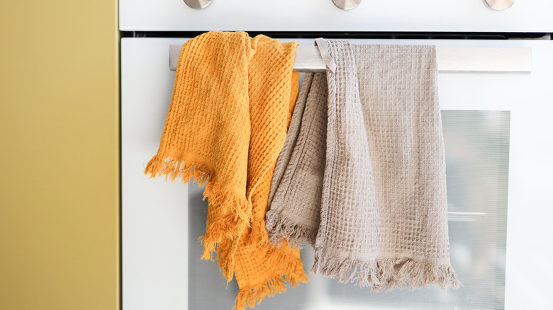 Two kitchen towels hanging on an over door.