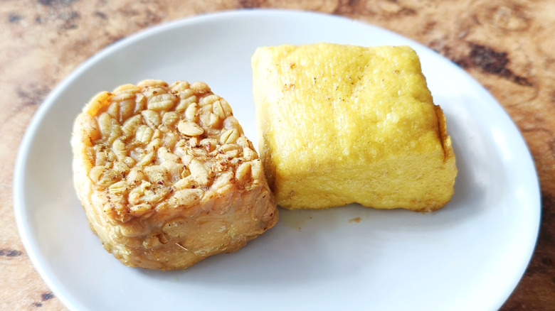 Fried tempeh and tofu on a white plate