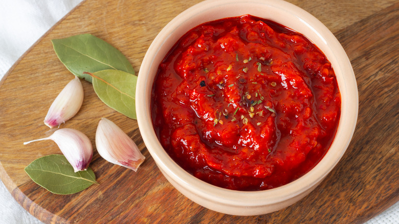 Tomato relish in a bowl with herbs and garlic