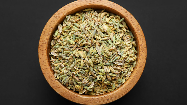 A bowl of fennel seeds photographed from above.