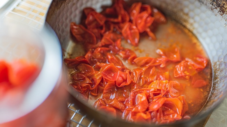 making tomato syrup in a pan