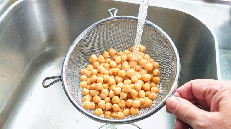 Chickpeas rinsing in strainer
