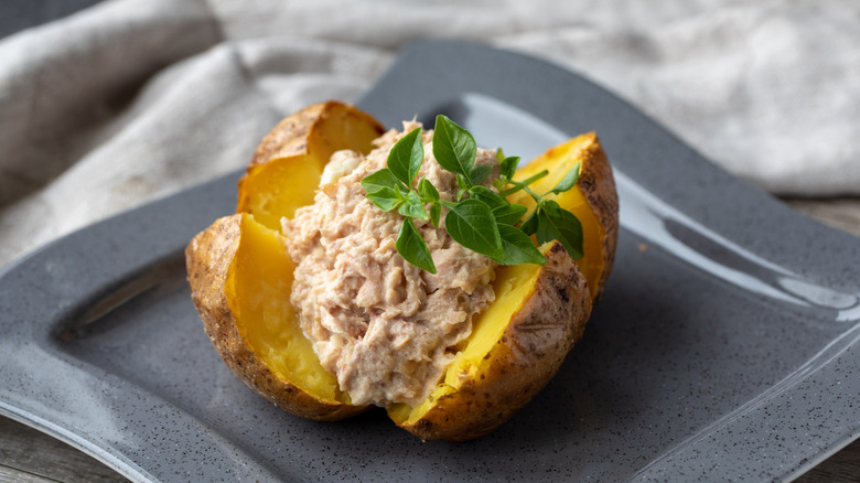 Baked potato with tuna salad on a plate
