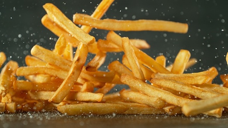 fries being tossed in salt