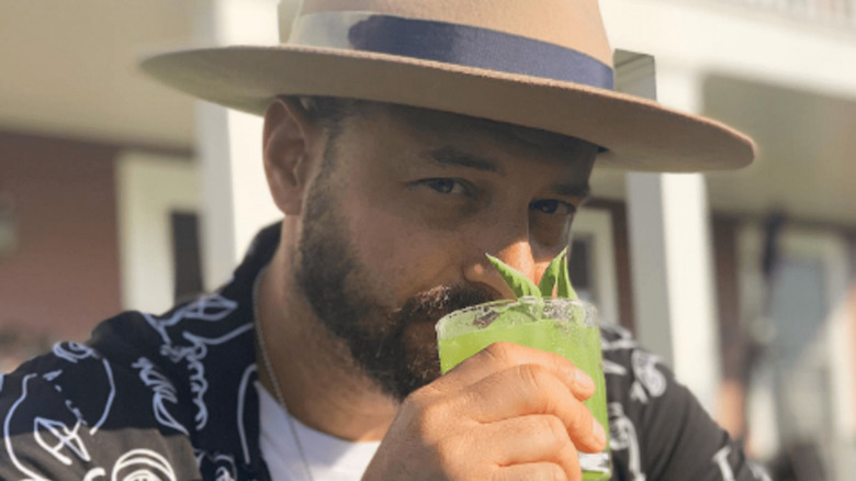 Cody Goldstein drinking a cocktail