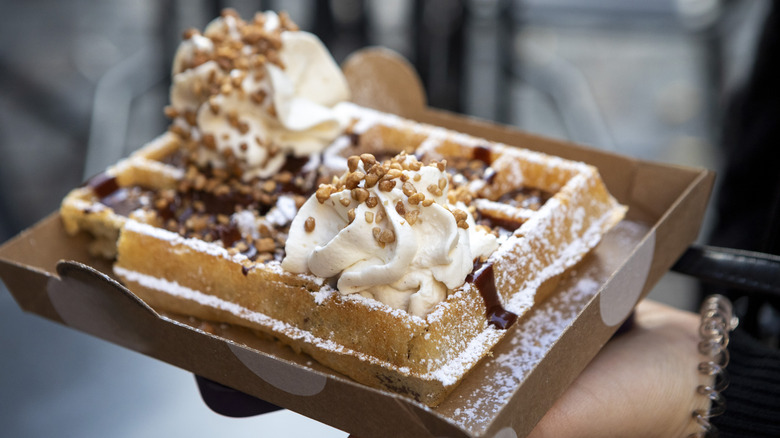 A person holding a Belgian waffle