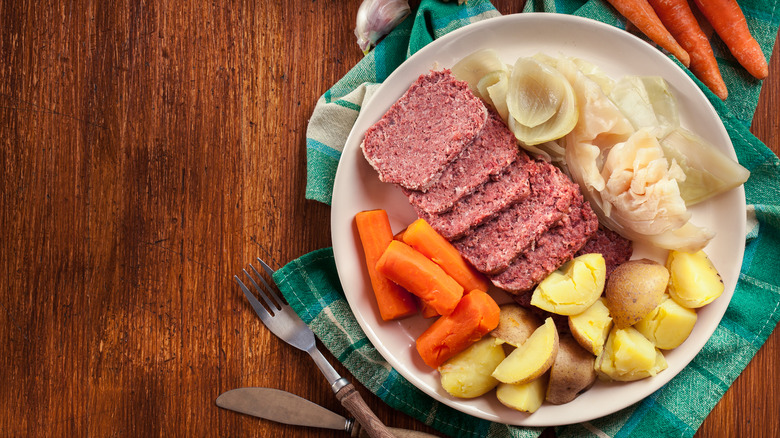 A plate of corned beef and cabbage on a table