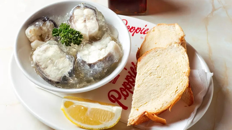 A bowl of jellied eels with bread and lemon at Poppies Fish & Chips