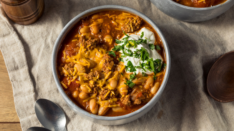 a bowl of turkey chili with beans and toppings