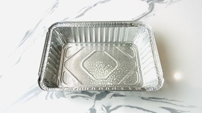 Disposable pan coated with cooking spray