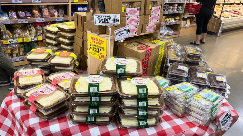 An array of desserts on a checkered tablecloth display table at Trader Joe's