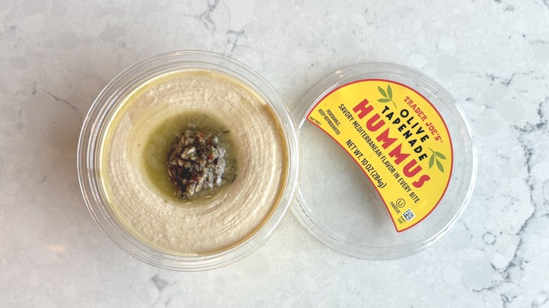 An open container of Trader Joe's Olive Tapenade Hummus