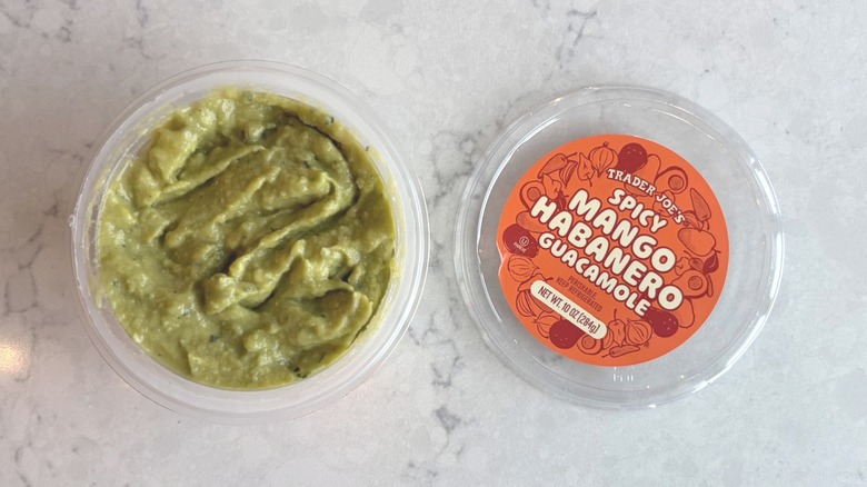 An open container of Trader Joe's Spicy Mango Habanero Guacamole