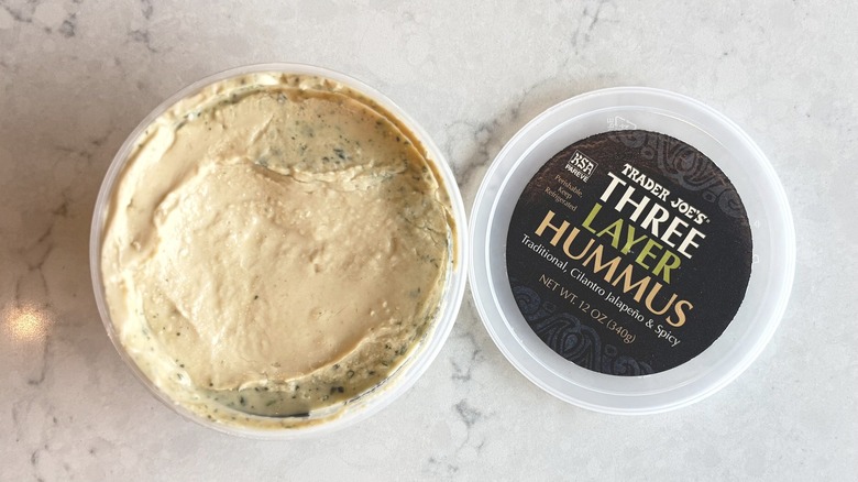 An open container of Trader Joe's Three Layer Hummus