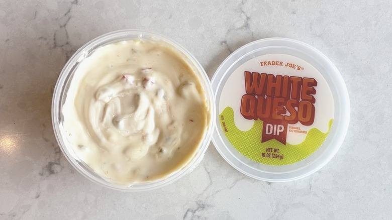 An open container of Trader Joe's White Queso Dip