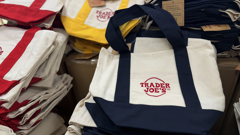 a pile of trader joe's reusable canvas bags