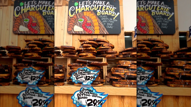 Trader Joe's large and small olive wood cutting boards on a shelf