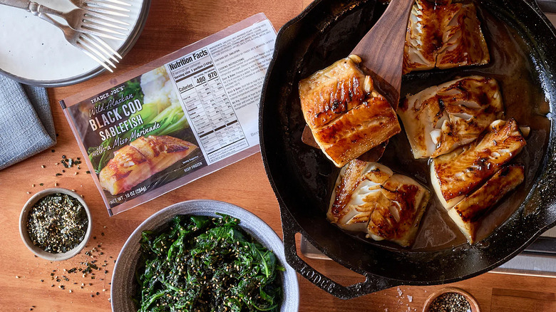 Trader Joe's Wild Alaskan Black Cod Sablefish with Miso Marinade cooked in a skillet next to the Trader Joe's packaging