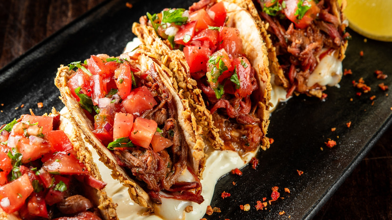 Crispy beef tacos in a row