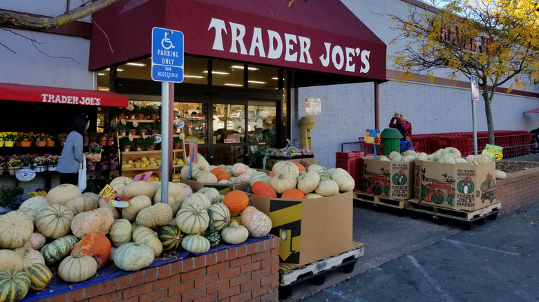 Exterior of a Trader Joe's with bins full of pumpkins and gourds
