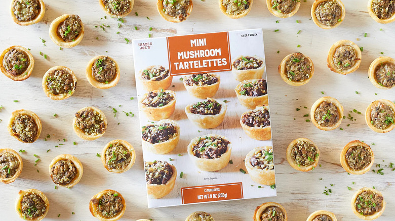 A package of Trader Joe's Mini Mushroom Tartelettes surrounded by cooked tartelettes