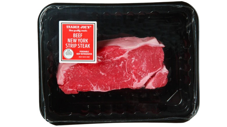 A package of Trader Joe's Beef New York Strip Steak on a white isolated background