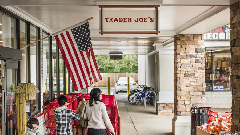 Shoppers in front of Trader Joe's with an American flag hanging