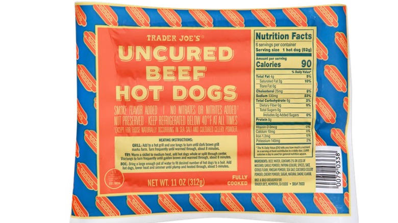 A package of Trader Joe's Uncured Beef Hot Dogs on a white isolated background