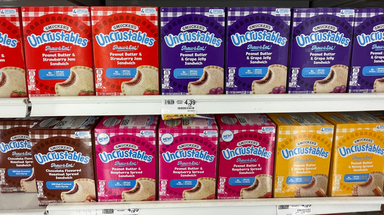 Display case full of Smucker's Uncrustables in various flavors