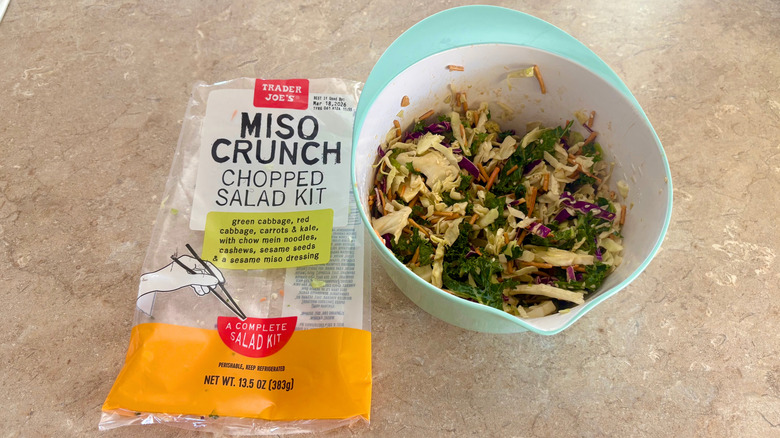 A prepared Miso Crunch Chopped Salad next to its empty bag