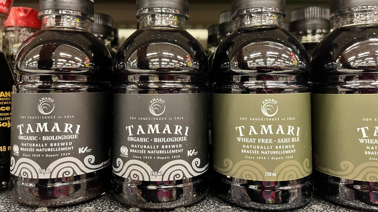 Bottles of tamari on a shelf.