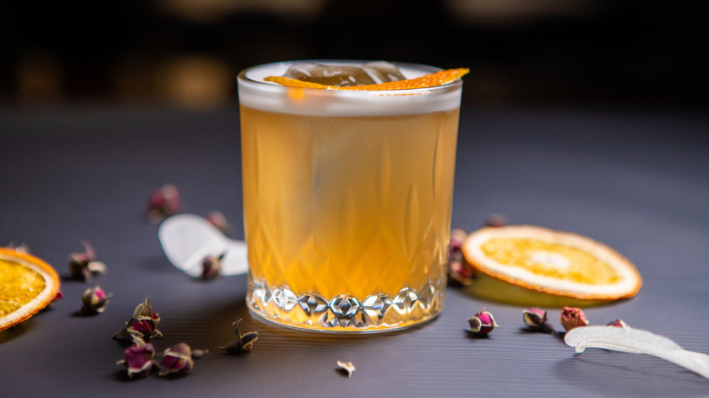 A whiskey sour is pictured in a rocks glass in profile