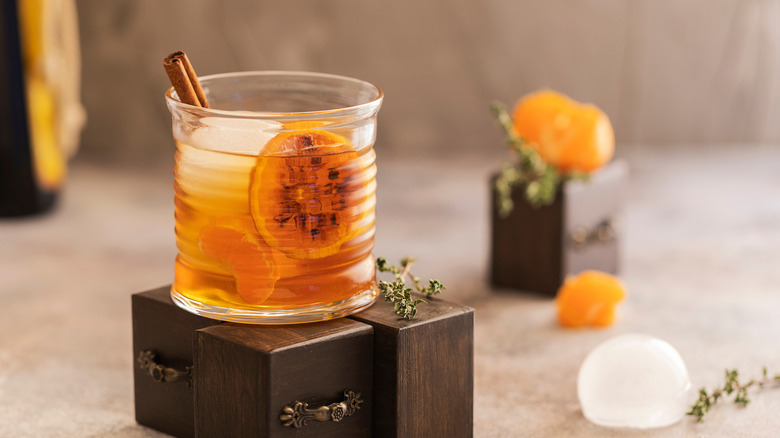 A whiskey sour is served with a cinnamon stick