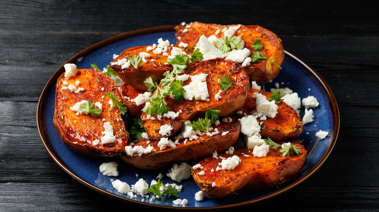 roasted sweet potato slices garnished with feta cheese