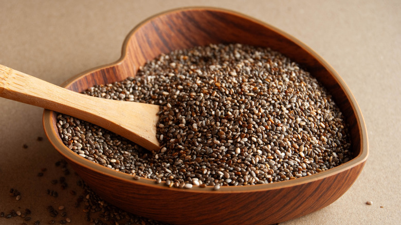 Chia seeds in a heart shaped wooden.