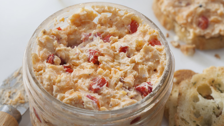A closeup of a jar of pimento cheese
