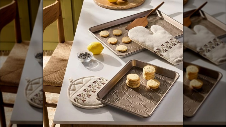 A stitched oven mitt and potholder set from Target in sour cream color.