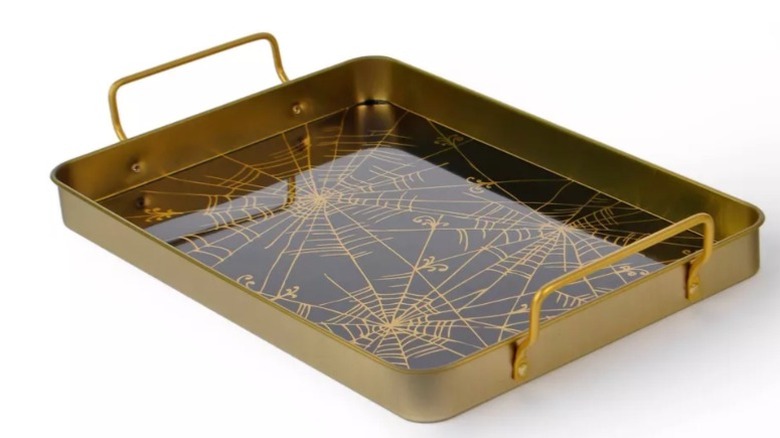 A decorative metal tray with a spiderweb design sold at Target.