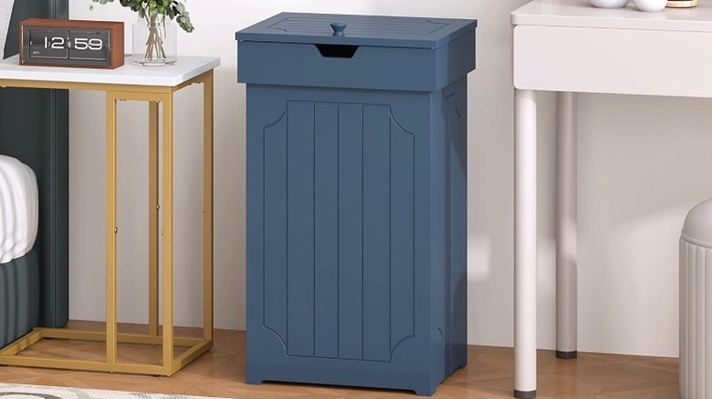 Tall and blue wooden trash can