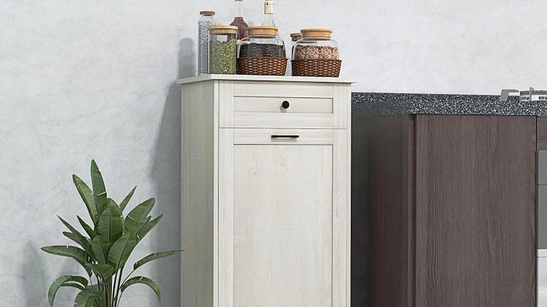 Rustic off-white wooden trash cabinet with drawer