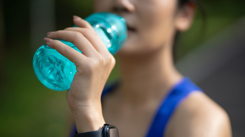 Woman sipping water on a walk