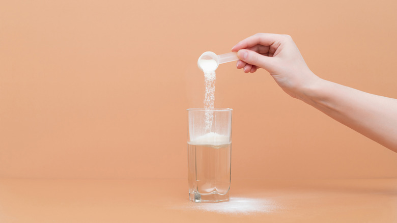 Pouring powder into water glass
