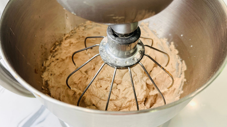 Chocolate cream filling in stand mixer bowl with whisk attachment